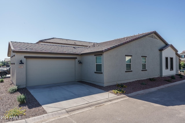 view of side of home featuring a garage