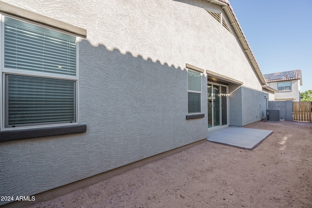 view of home's exterior with central air condition unit and a patio