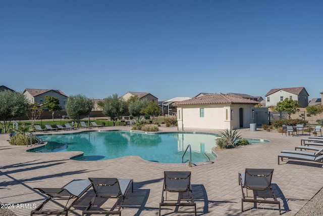 view of swimming pool featuring a patio area