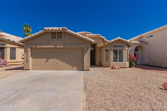 4526 E Bannock St, Phoenix, AZ 85044 - view of front of home with stucco siding, an attached garage, driveway, and a tile roof