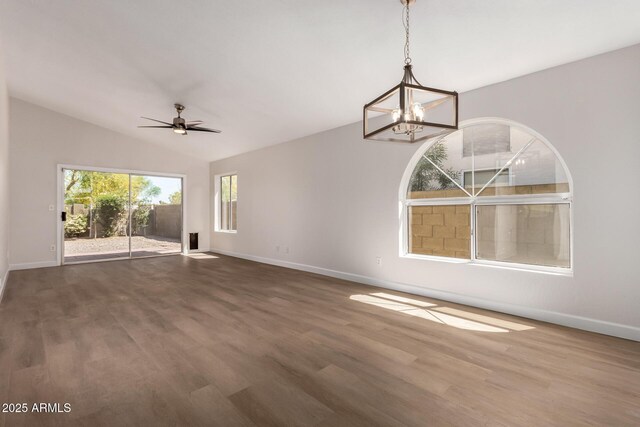 4526 E Bannock St, Phoenix, AZ 85044 - unfurnished room featuring baseboards, dark wood-type flooring, a chandelier, ceiling fan, and lofted ceiling