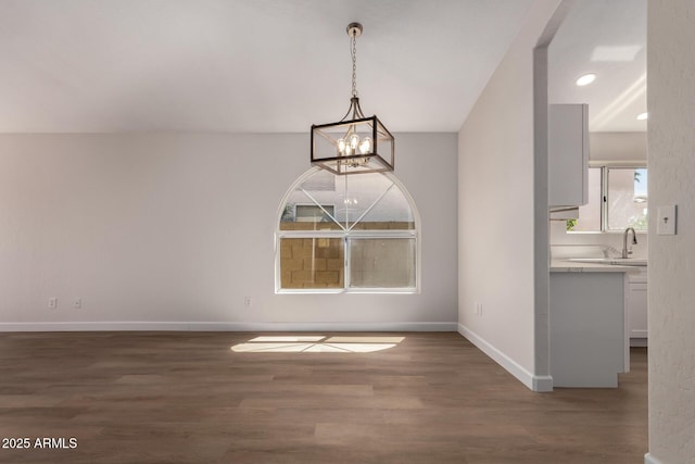 4526 E Bannock St, Phoenix, AZ 85044 - unfurnished dining area featuring a chandelier, wood finished floors, baseboards, and recessed lighting