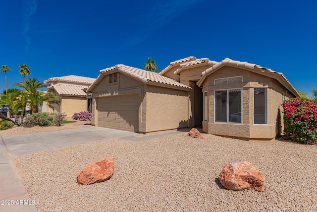 4526 E Bannock St, Phoenix, AZ 85044 - mediterranean / spanish home featuring a garage, driveway, stucco siding, and a tile roof