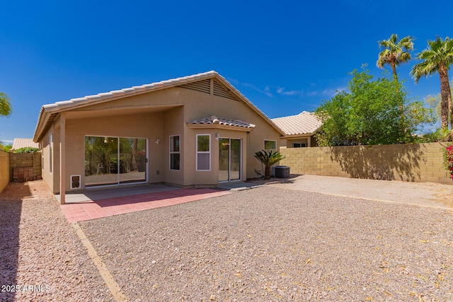4526 E Bannock St, Phoenix, AZ 85044 - back of house with stucco siding, a tile roof, a fenced backyard, and a patio