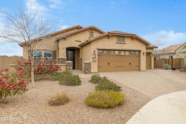 view of front of home featuring a garage, fence, decorative driveway, and stucco siding