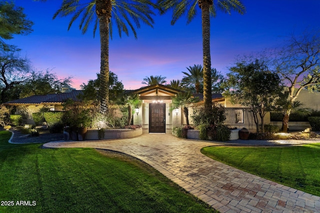 view of front of property with a lawn