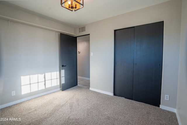 unfurnished bedroom with carpet and a closet