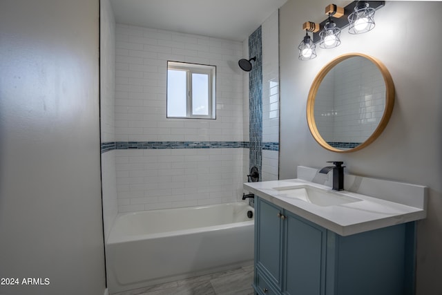 bathroom with vanity and tiled shower / bath combo