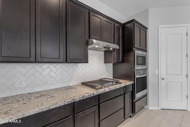 22788 E Orion Way, Queen Creek, AZ 85142 - kitchen with stainless steel appliances, under cabinet range hood, light stone counters, light tile patterned flooring, and tasteful backsplash