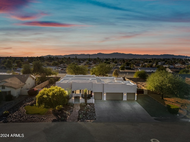 aerial view at dusk featuring a mountain view