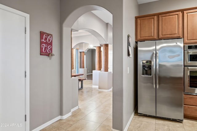 kitchen with stainless steel appliances and light tile patterned floors