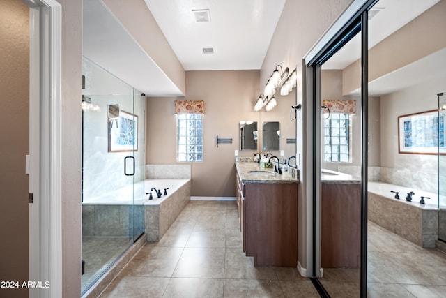 bathroom featuring tile patterned flooring, shower with separate bathtub, and vanity