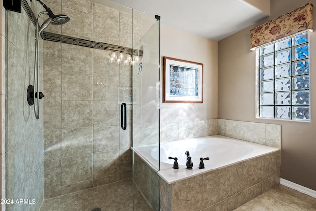 bathroom featuring independent shower and bath, tile patterned flooring, and plenty of natural light