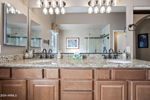 bathroom with walk in shower and vanity