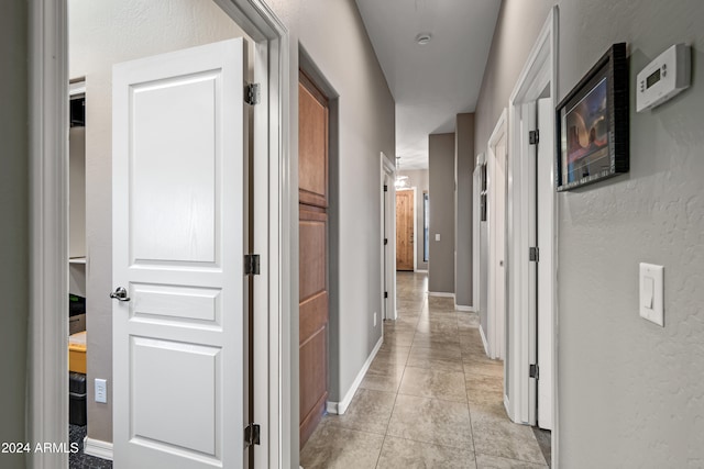 corridor featuring light tile patterned floors