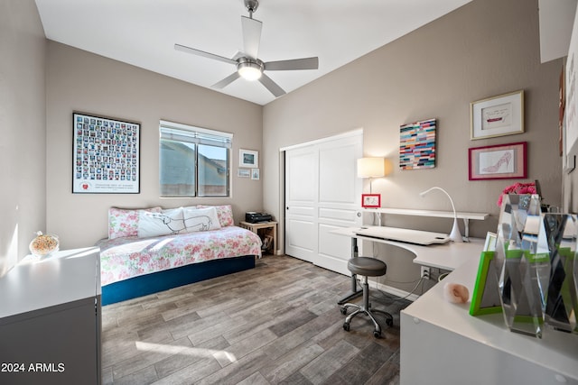 bedroom featuring wood-type flooring, ceiling fan, and a closet