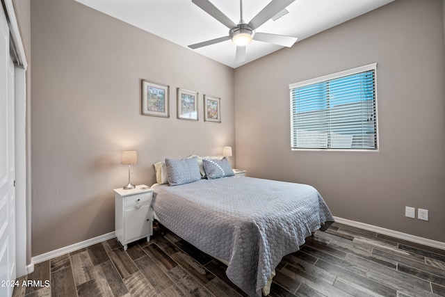 bedroom with a closet, ceiling fan, and dark hardwood / wood-style floors