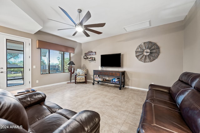 living room featuring ceiling fan and light tile patterned floors