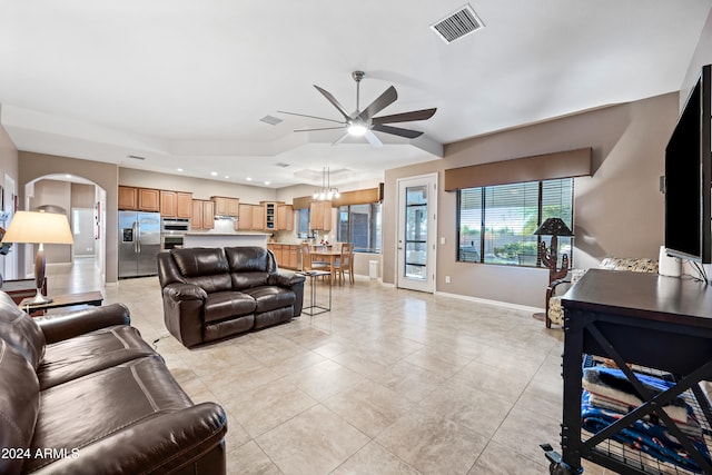 living room with ceiling fan with notable chandelier and light tile patterned floors