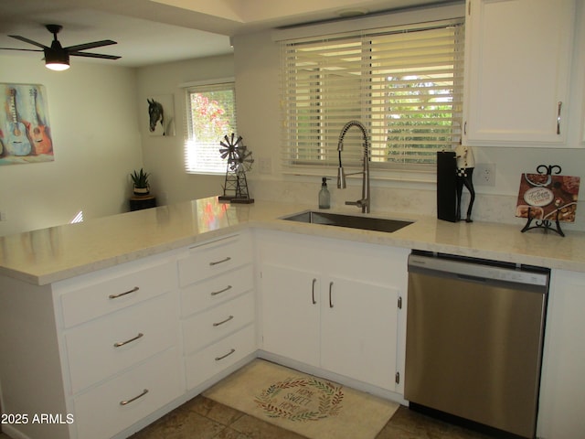 kitchen with sink, white cabinetry, light stone counters, dishwasher, and ceiling fan