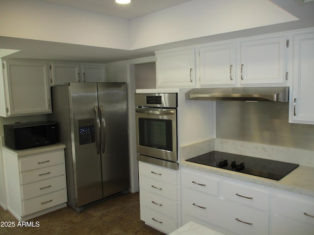 kitchen featuring white cabinetry, decorative backsplash, and black appliances