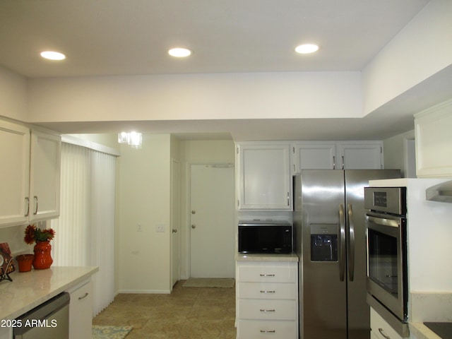 kitchen featuring stainless steel appliances and white cabinets