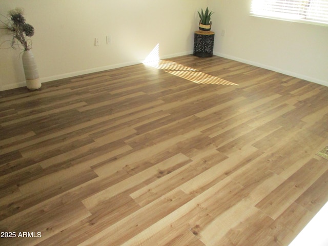 unfurnished room featuring hardwood / wood-style flooring