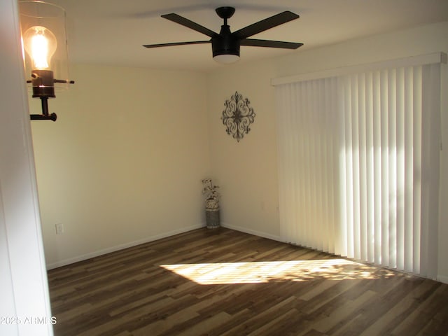 empty room featuring dark hardwood / wood-style floors and ceiling fan