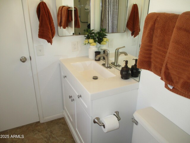 bathroom featuring vanity and toilet