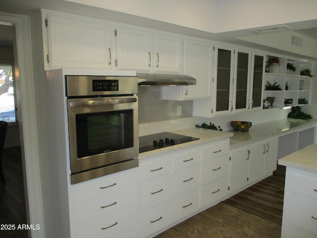 kitchen featuring white cabinetry, dark wood-type flooring, stainless steel oven, and black electric cooktop