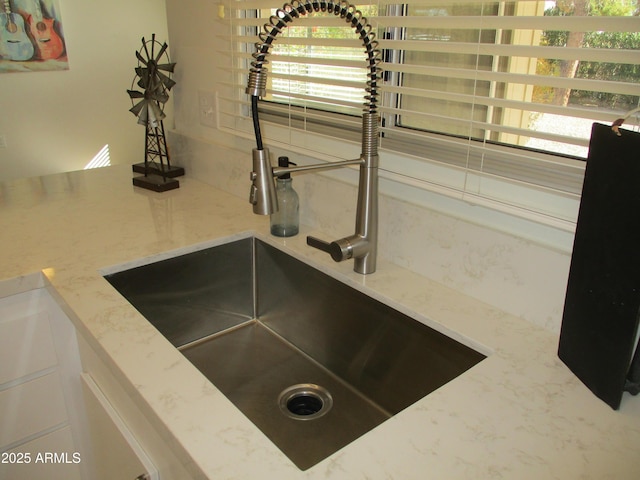 room details with light stone counters and sink