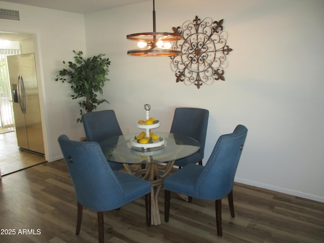 dining space with dark hardwood / wood-style flooring