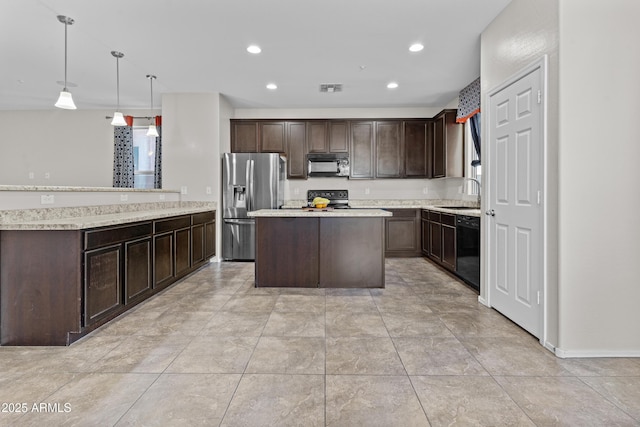 kitchen featuring sink, a center island, dark brown cabinetry, black appliances, and decorative light fixtures