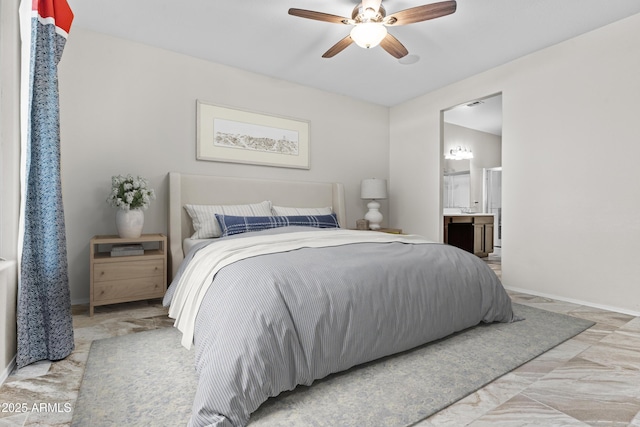 bedroom with ceiling fan and ensuite bath