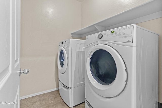 laundry area featuring washing machine and clothes dryer