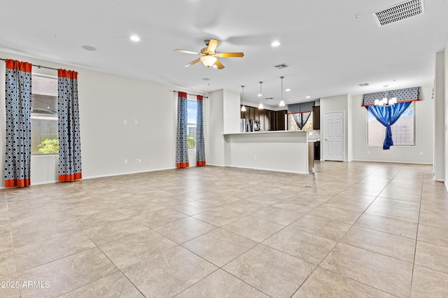 interior space with light tile patterned floors and ceiling fan with notable chandelier