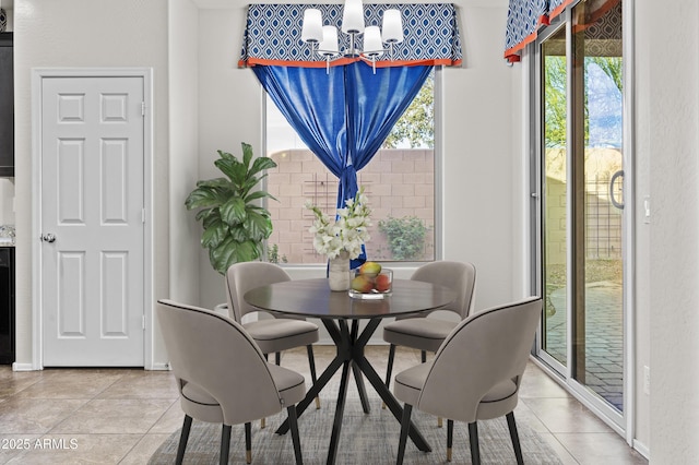 tiled dining space featuring a notable chandelier