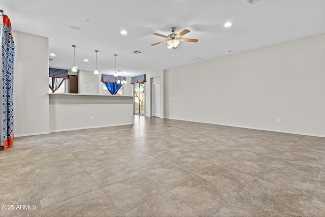 unfurnished living room with ceiling fan