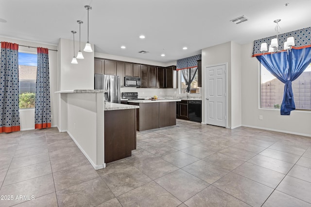 kitchen with dark brown cabinetry, hanging light fixtures, a notable chandelier, and black appliances