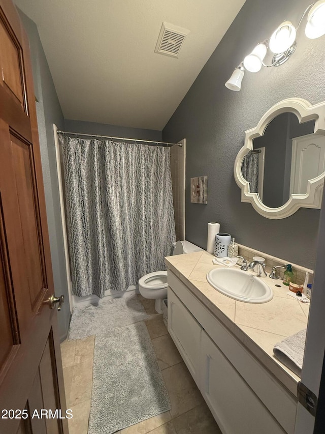 bathroom featuring curtained shower, visible vents, toilet, vanity, and tile patterned flooring