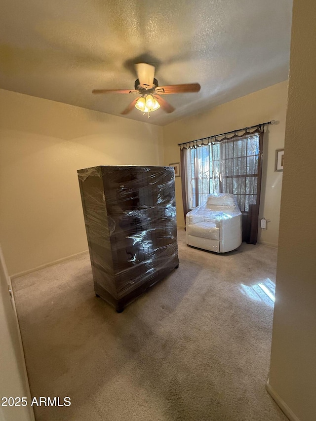 unfurnished bedroom with carpet, ceiling fan, and a textured ceiling