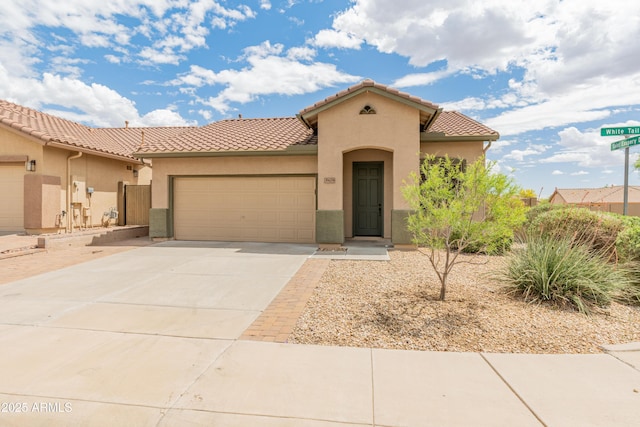 39609 N White Tail Ln, Anthem, AZ 85086 - mediterranean / spanish home with stucco siding, an attached garage, concrete driveway, and a tile roof