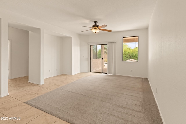 39609 N White Tail Ln, Anthem, AZ 85086 - unfurnished room featuring light tile patterned flooring, baseboards, and ceiling fan