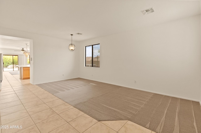 39609 N White Tail Ln, Anthem, AZ 85086 - empty room with visible vents, baseboards, light colored carpet, and light tile patterned flooring