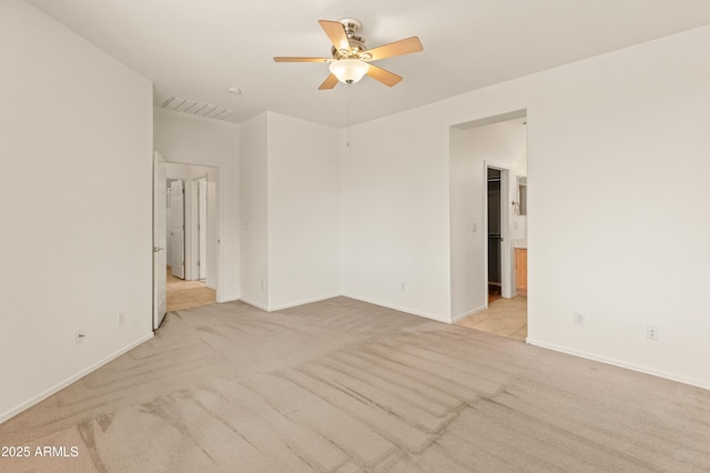 39609 N White Tail Ln, Anthem, AZ 85086 - empty room with visible vents, a ceiling fan, baseboards, and light carpet