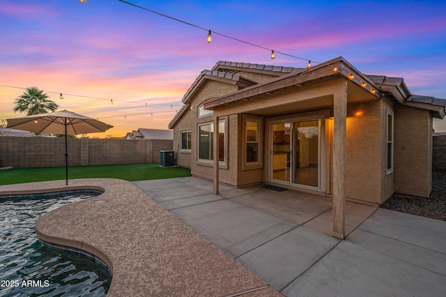 6309 W Hughes Dr, Phoenix, AZ 85043 - rear view of house with central AC unit, a fenced backyard, and a patio