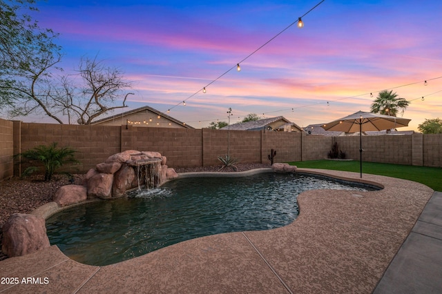 6309 W Hughes Dr, Phoenix, AZ 85043 - pool at dusk featuring a fenced backyard