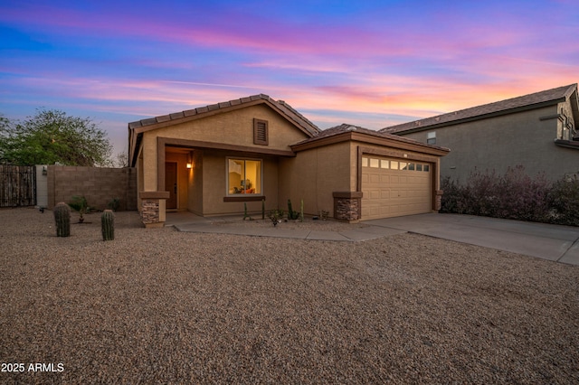 6309 W Hughes Dr, Phoenix, AZ 85043 - view of front of home with an attached garage, stucco siding, and concrete driveway