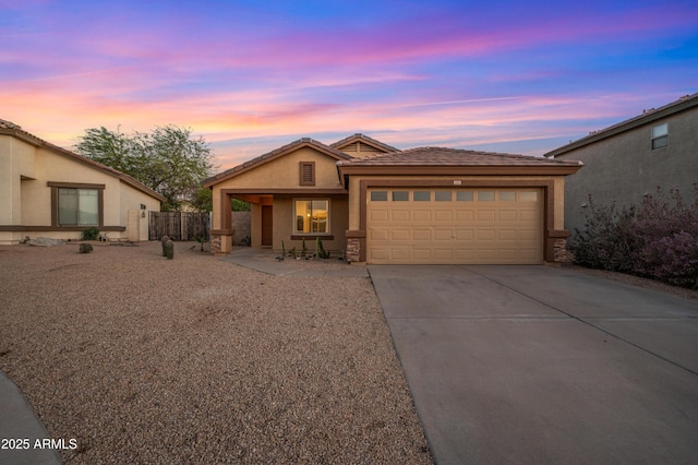 6309 W Hughes Dr, Phoenix, AZ 85043 - view of front of home with an attached garage, driveway, stucco siding, and a tile roof