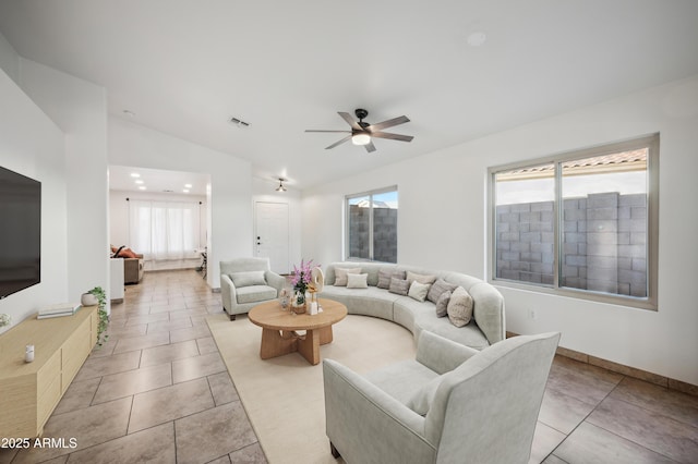 6309 W Hughes Dr, Phoenix, AZ 85043 - living area featuring vaulted ceiling, a ceiling fan, healthy amount of natural light, light tile patterned floors, and baseboards